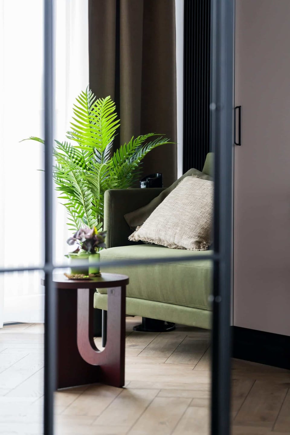 A side table with a plant, adding greenery and warmth to the space.

