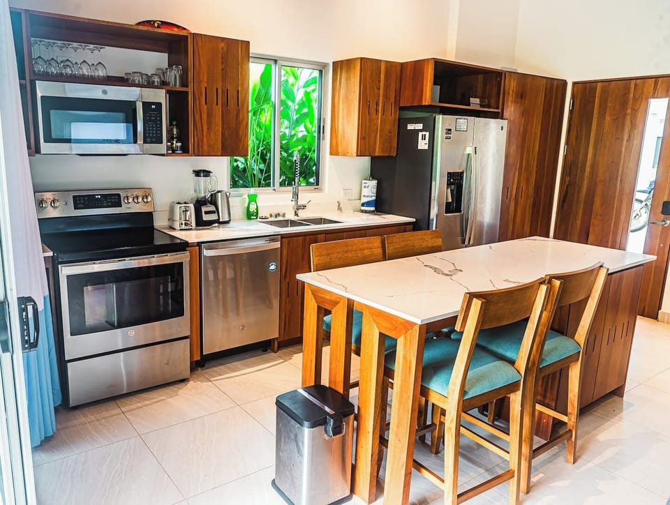 A bright and stylish kitchen with modern cabinetry and a spacious island.
