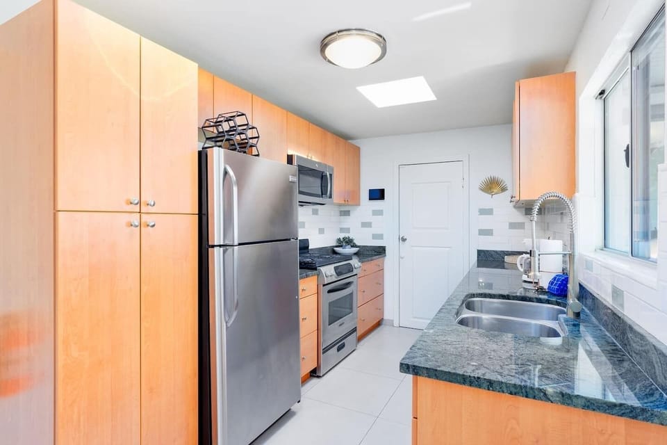 Kitchen features stainless steel appliances and cooking essentials