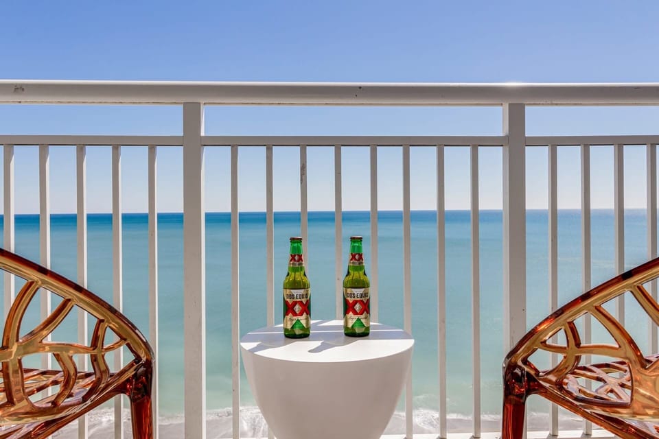 Escape to your private balcony with panoramic ocean views, perfect for unwinding with a drink in hand. Feel the sea breeze, soak in the sights of the beach below, and create unforgettable moments in this serene retreat.