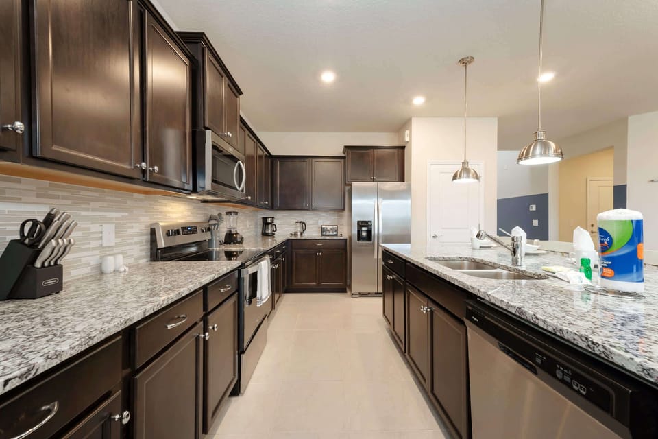 Modern kitchen with granite countertops and stainless steel appliances, perfect for cooking up family feasts.
