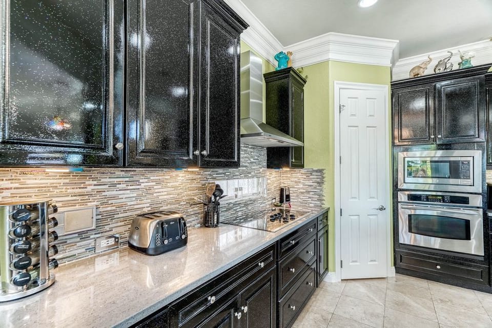 Your gourmet kitchen features granite countertops, a striking mosaic backsplash, and premium appliances for memorable culinary adventures.