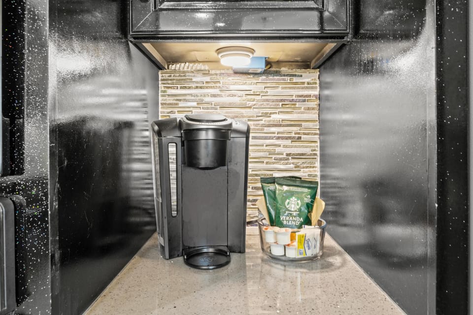 Start your mornings right with a premium coffee maker and quality beans, perfectly positioned for your convenience.