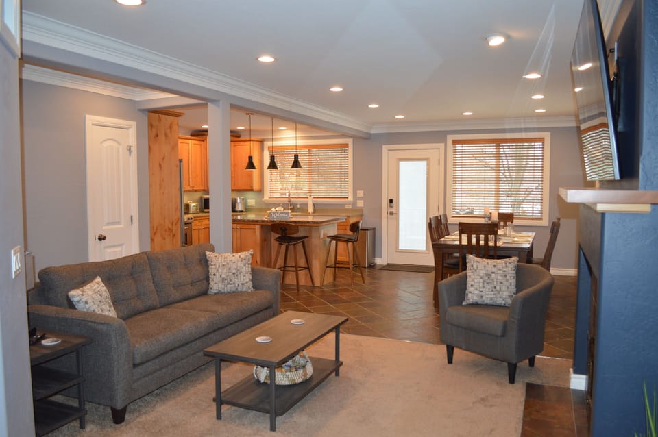 Open floor plan, living room, kitchen with island, and dining room.