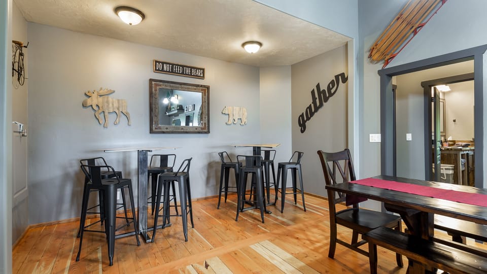 This cozy dining room area provides three bistro tables to sit down for a quick snack or play a game of cards with friends. They are also convenient for serving tables or overflow dining when needed.