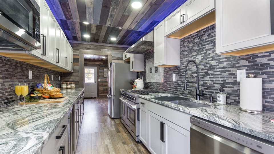 Even in the mountains, you can enjoy cooking top-notch meals in a gourmet kitchen.  Make memories and impress your guests with your cooking skills by utilizing this stunning kitchen setup.