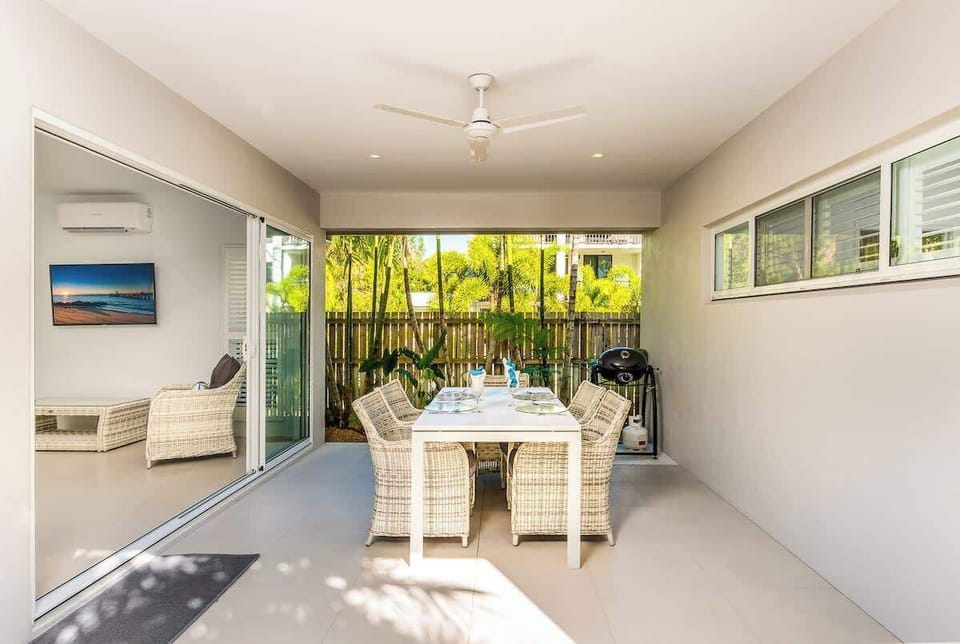 The living area flows seamlessly to the undercover patio, where you'll find a dining setting with BBQ