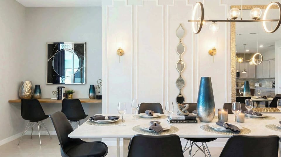 Chic dining space with a stylish two-person workspace and modern artistic flair.