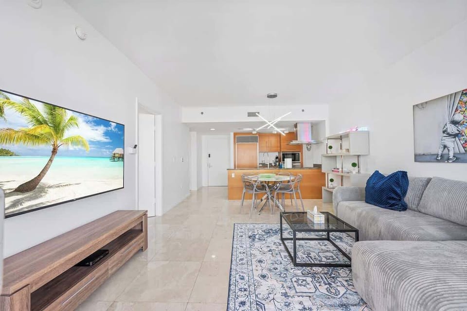 Alternate angle of the stylish, sun-drenched living room.