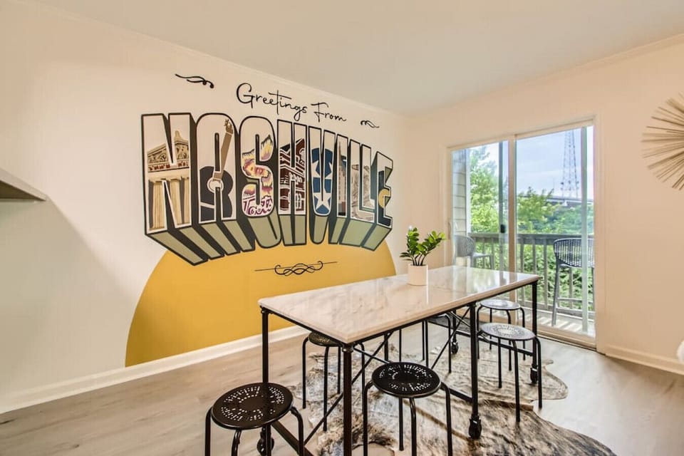 Dining table with seating for 6. The dining area opens up into the living room. Private patio off of this room. Take a photo in front of our custom Nashville mural.