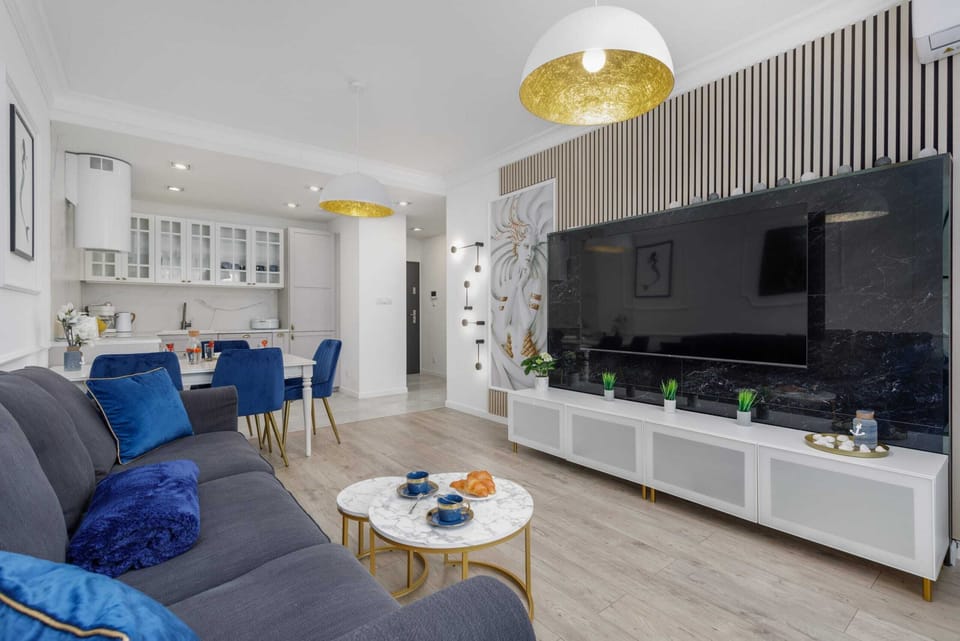 A spacious living and dining area with a blue and white color palette, creating a chic look.
