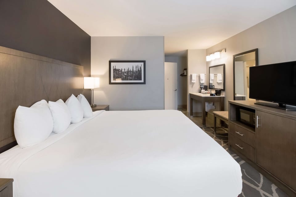 Desk, laptop workspace, blackout drapes, iron/ironing board