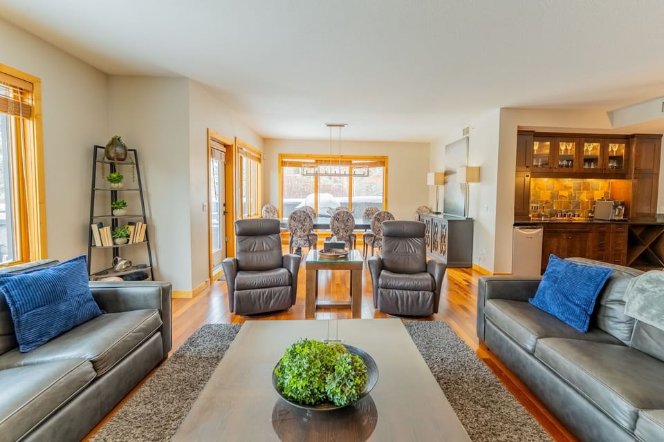 Living room with multiple seating areas and dining table