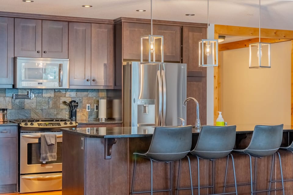 Kitchen with stainless steel appliances and pendant lighting