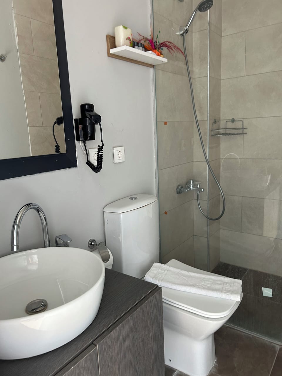 Shower, hair dryer, slippers, towels