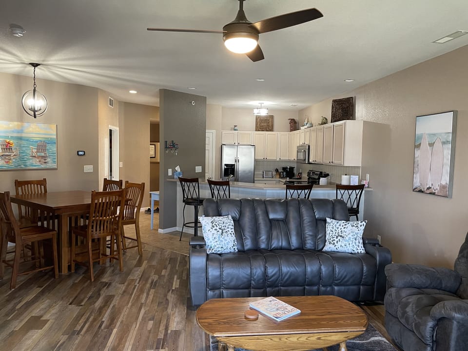 Open concept with view of living area, kitchen and dining.  Note table for 6