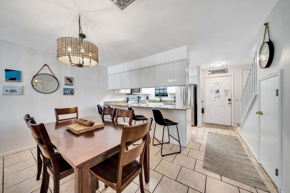 There is a dining table that seats 6, perfect for sharing a meal or playing a game, as well as additional breakfast bar seating.