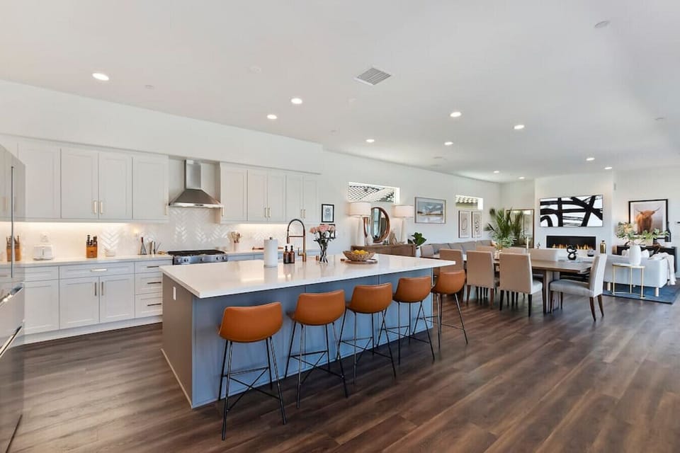 Spacious kitchen w/ large island, bar seating & sleek finishes for cooking & conversation