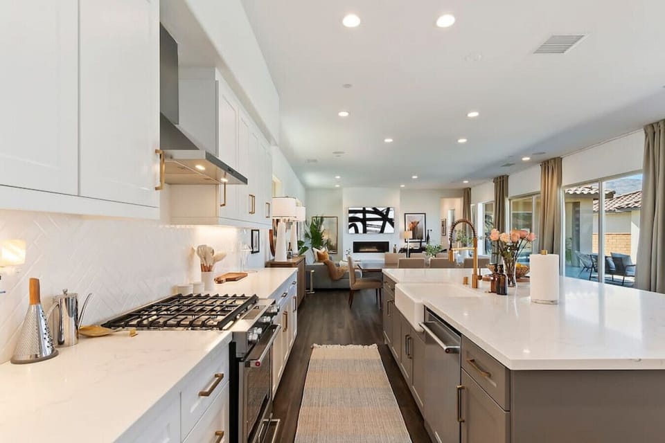 Bright galley kitchen w/ long counters, stainless appliances & plenty of prep space