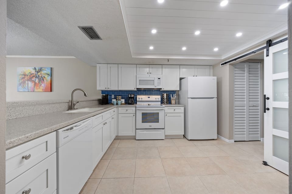 Fully stocked custom kitchen open to the living room.