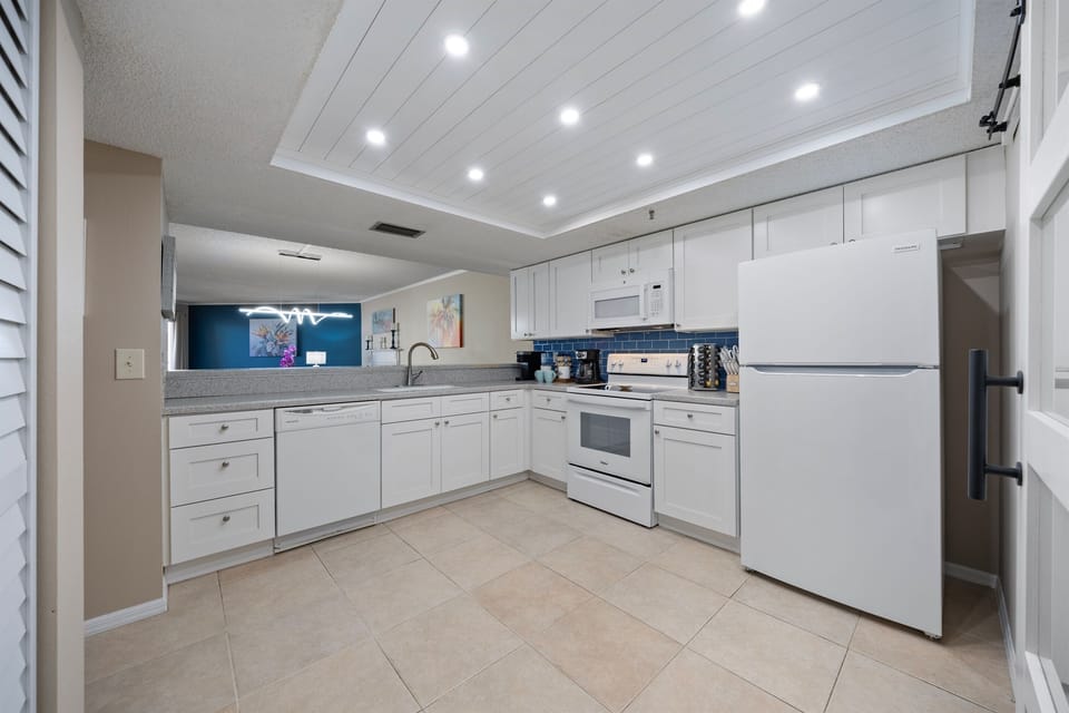 Fully stocked custom kitchen open to the living room.