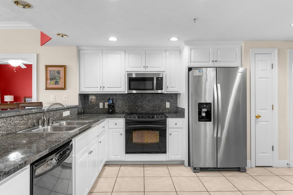 Modern kitchen with stainless steel appliances and granite countertops