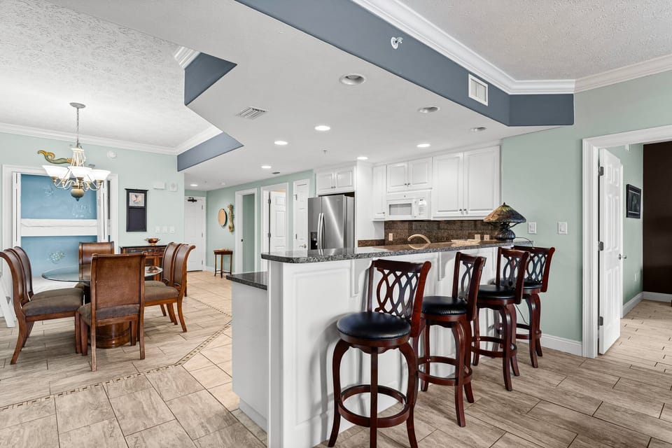 Open kitchen w/ bar seating — perfect for casual breakfasts before hitting the beach.