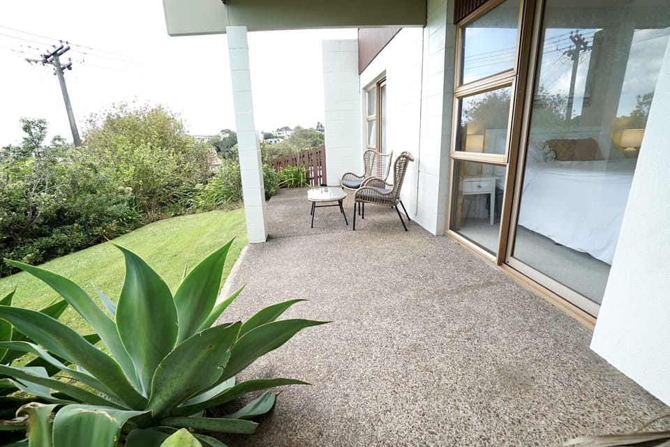 Outdoor area with private entrance and covering looking over beach area 