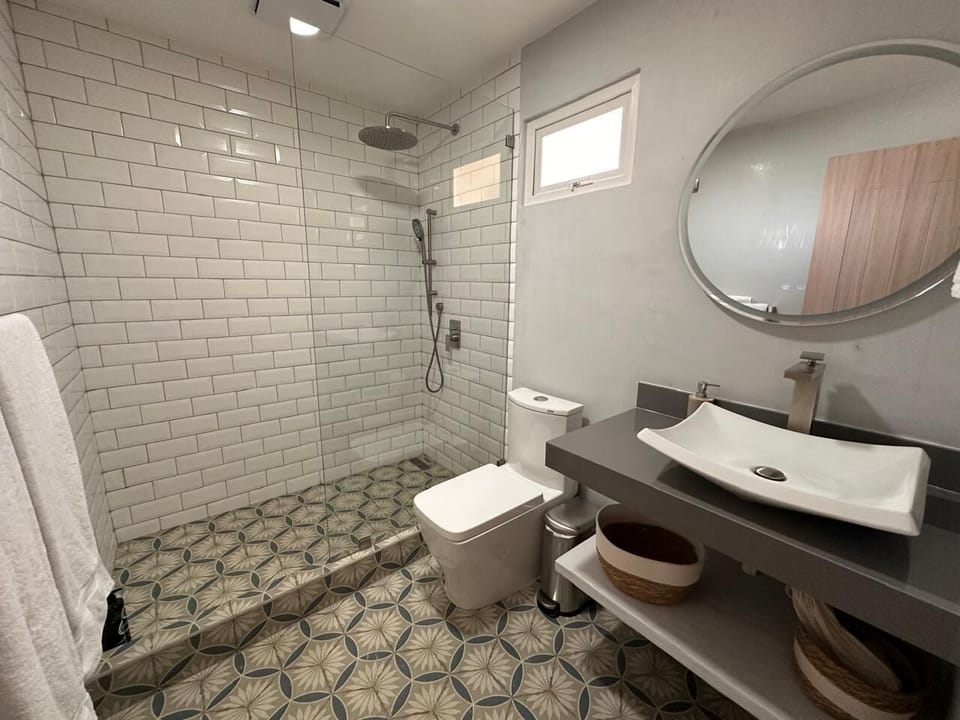 Deluxe Quadruple Room, 2 Double Beds | Bathroom | Shower, free toiletries, hair dryer, towels
