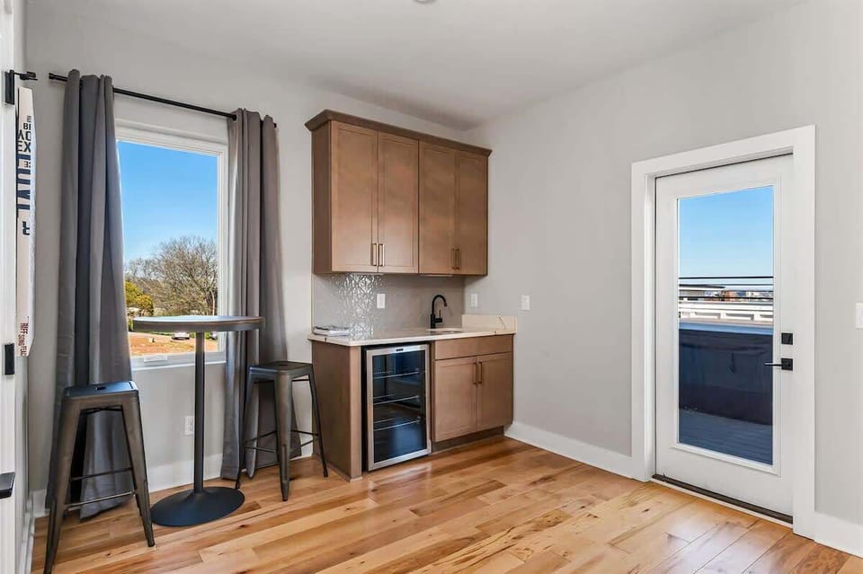Modern wet bar area connecting effortlessly to the rooftop lounge space.