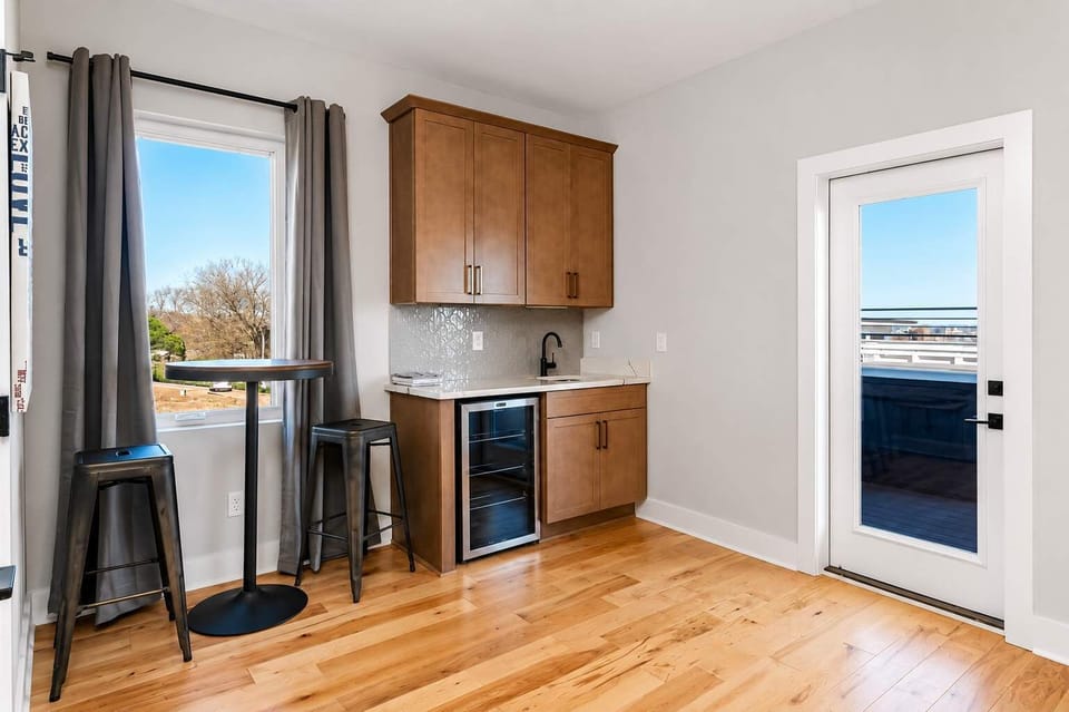 Modern wet bar area connecting effortlessly to the rooftop lounge space.
