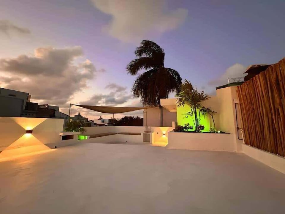 SHARED rooftop lounge area in the evening.
