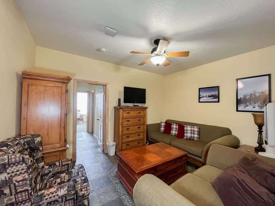 Relax in this inviting living room, designed for comfort and leisure. You will love the cozy seating, classic wooden furniture, and warm, welcoming atmosphere, ideal for unwinding after a day of exploring the great outdoors. (Large living area)