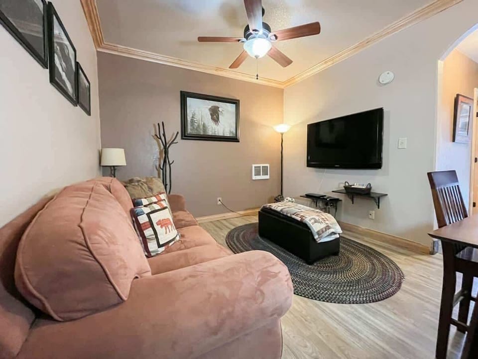 Relax in the comfort of a tastefully decorated living room, where you can enjoy your favorite shows on a large screen TV or unwind with a good book. The inviting sofa and thoughtful touches make this a perfect spot to relax. (Large main living area with pull-out sofa, dining area, and flatscreen TV)