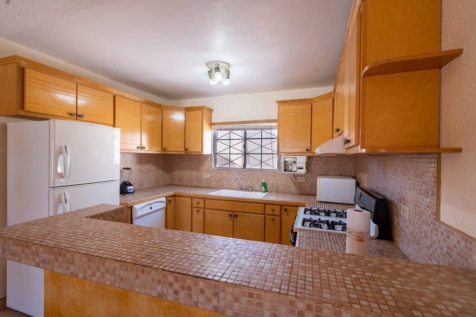 Ample kitchen counter space at Casa Seascape for meal prep — full kitchen with refrigerator and microwave .