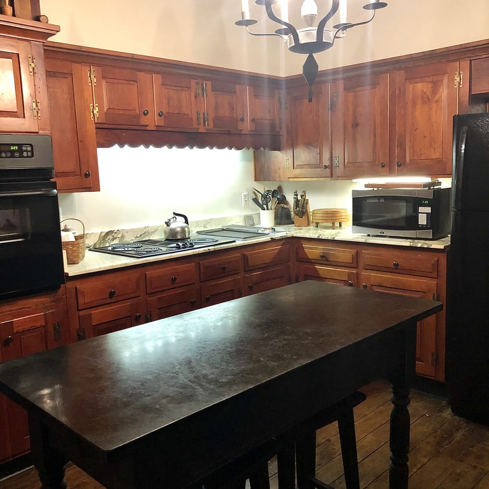 View of the  electric range, griddle and marble counters.