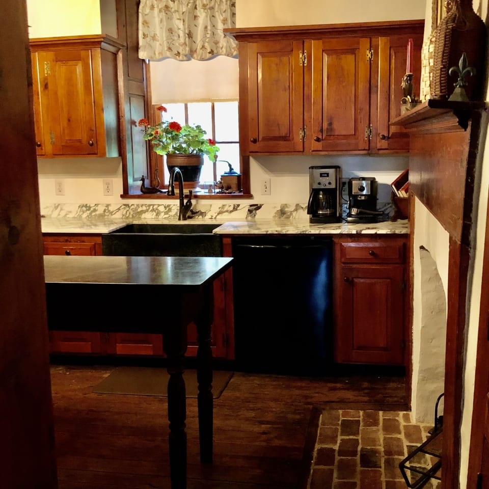 The soapstone sink, custom cabinets and window overlooking the herb garden. 