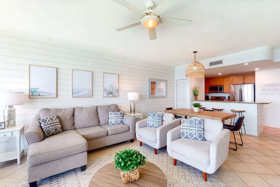 Relax in your bright, coastal-inspired living space with comfortable seating and an open kitchen where you can prepare meals together.