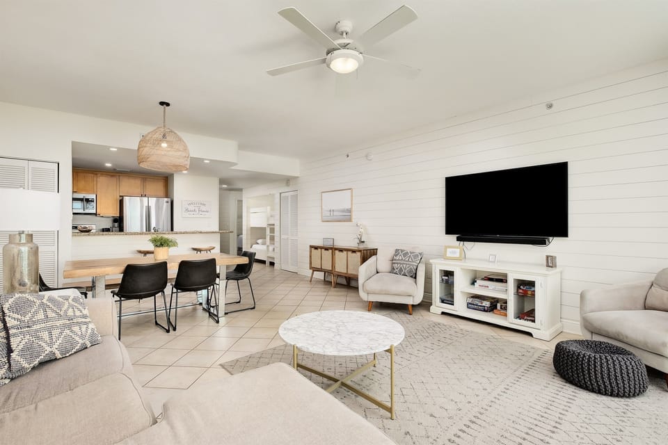 Relax in your spacious open-concept living space with modern coastal style, complete with comfortable seating and entertainment center.