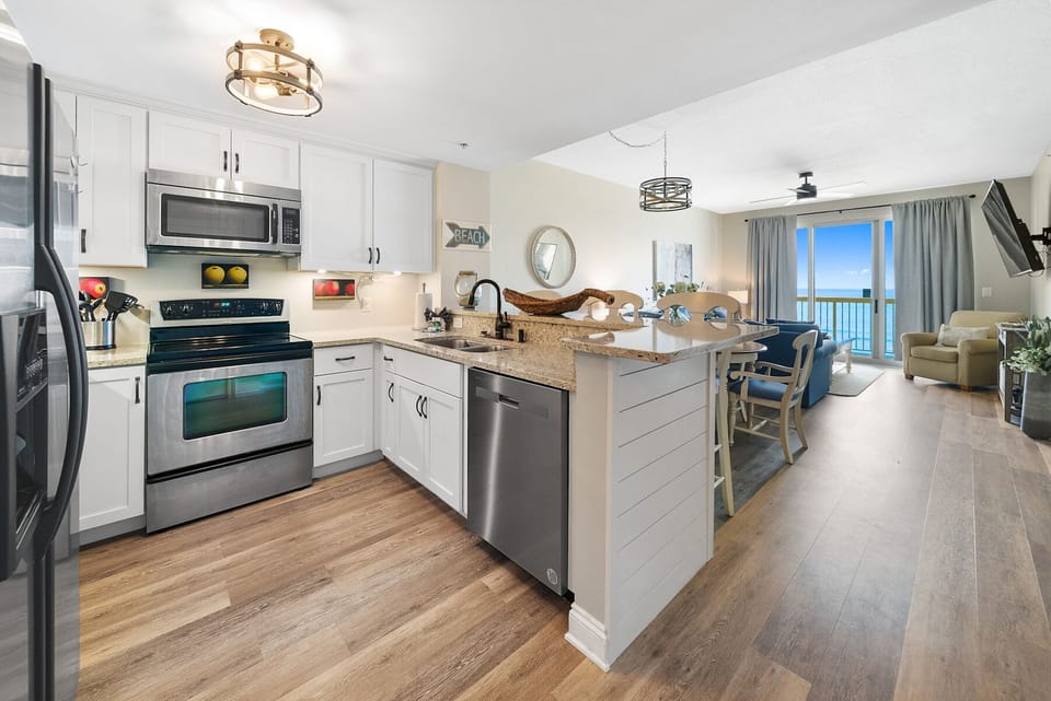 Your gourmet kitchen offers granite counters, stainless appliances, and a breakfast bar where you'll enjoy morning coffee with stunning ocean views.