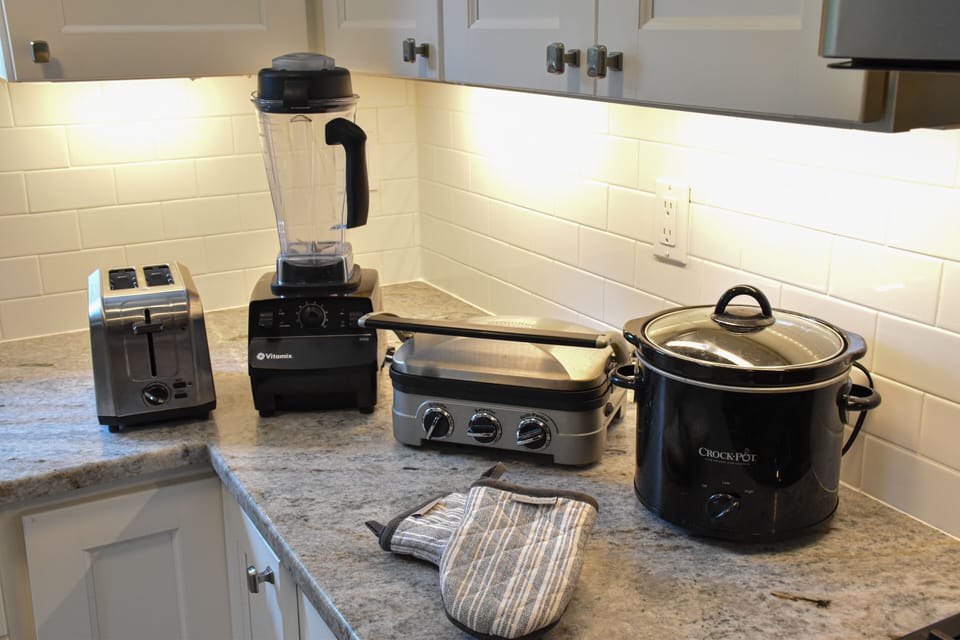 Toaster, blender, grill, crockpot plus plenty of pots and pans