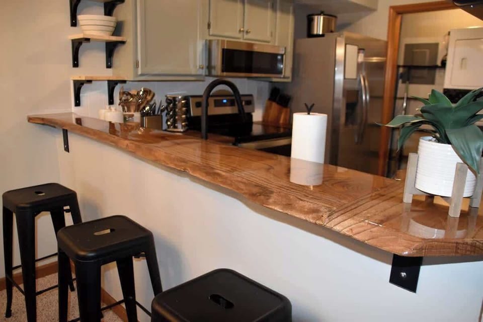 Beautiful custom live-edge bar with 3 barstools.