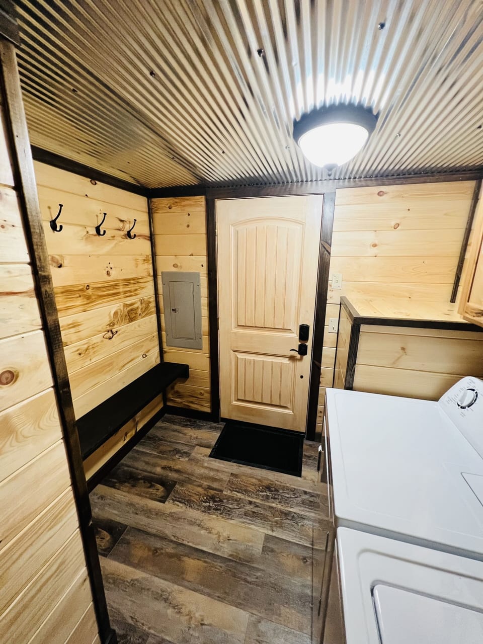 Laundry room with bench and coat hooks