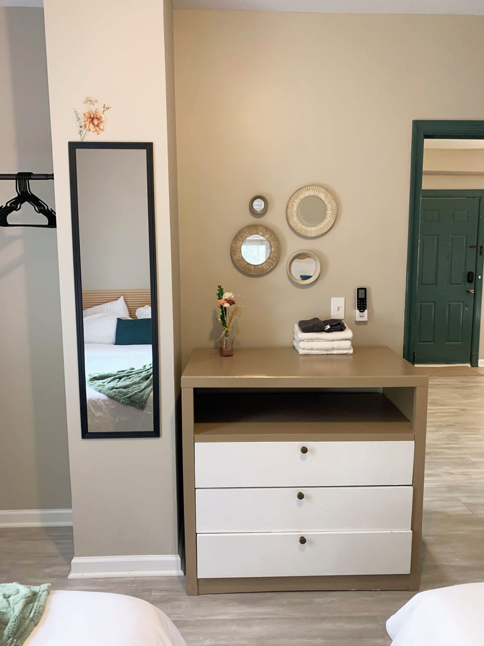 Stylish entry nook with dresser, full-length mirror, and keyless access