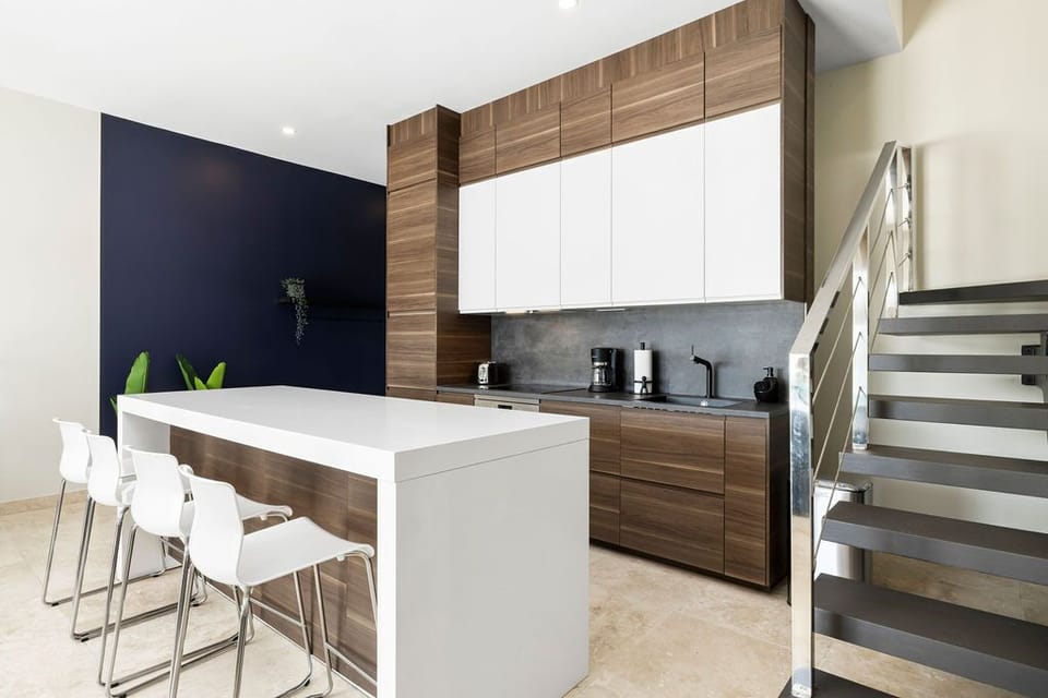 Gather at this sleek breakfast bar in your modern kitchen, perfectly designed for morning coffee and conversations with loved ones.