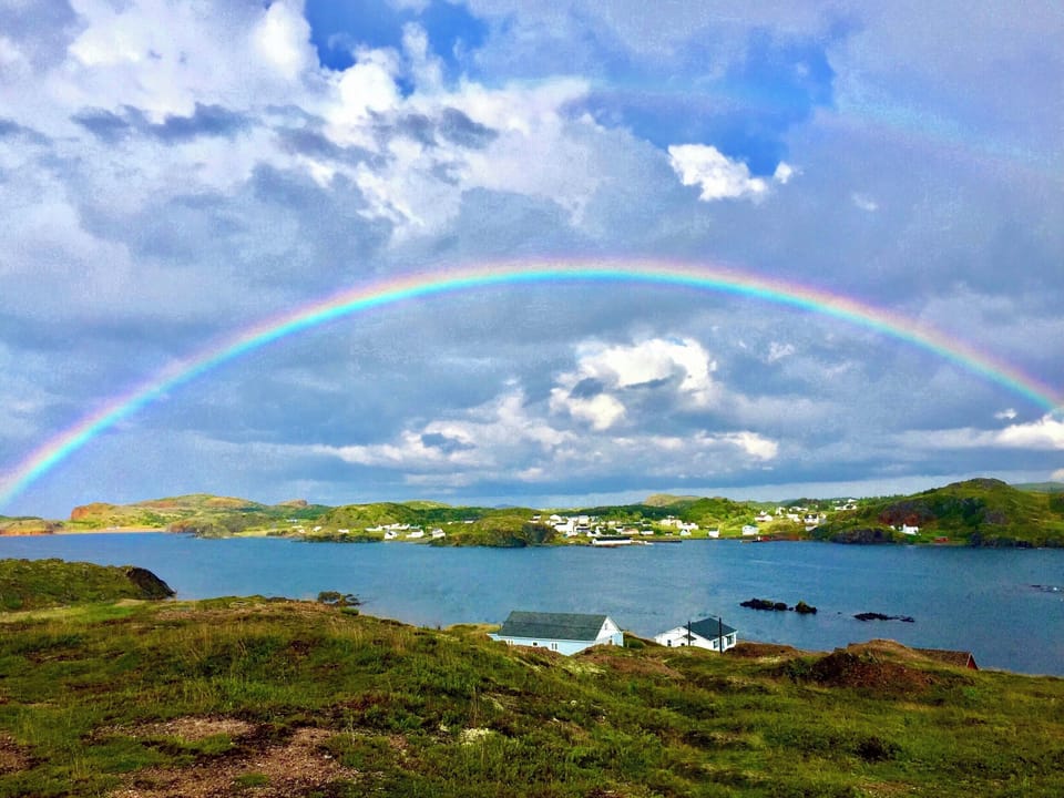 Beautiful rainbow over White’s Landing )blue house in the foreground)