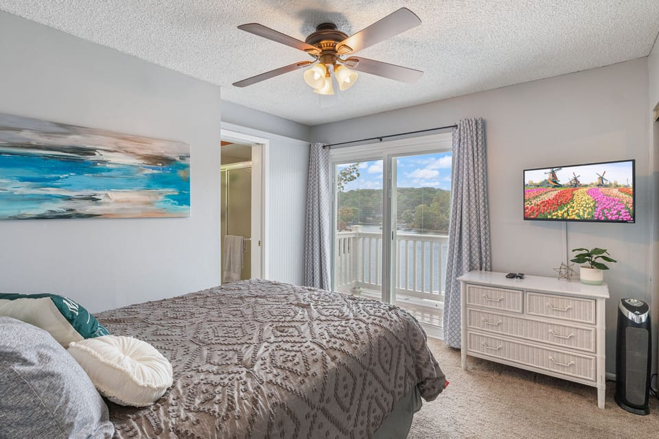 Master bedroom offers lake views and balcony access.