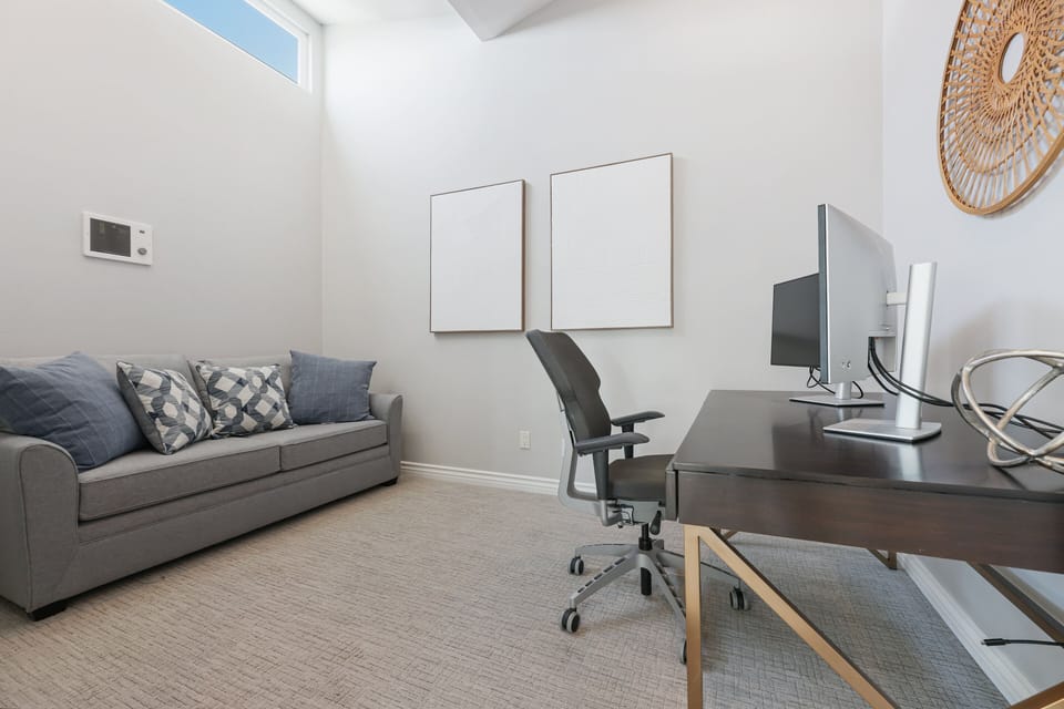 Off of the living room is a room with a full size sofa bed and an office desk. The computers are no longer in the home.