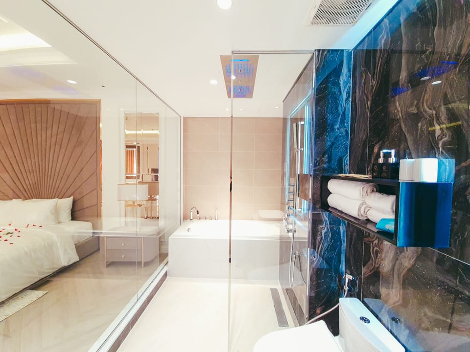 Deep soaking tub, hydromassage showerhead, designer toiletries