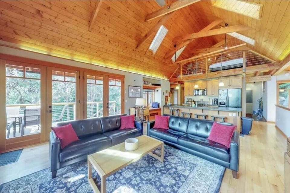 Living room on the main floor with access to the upper deck and lake views